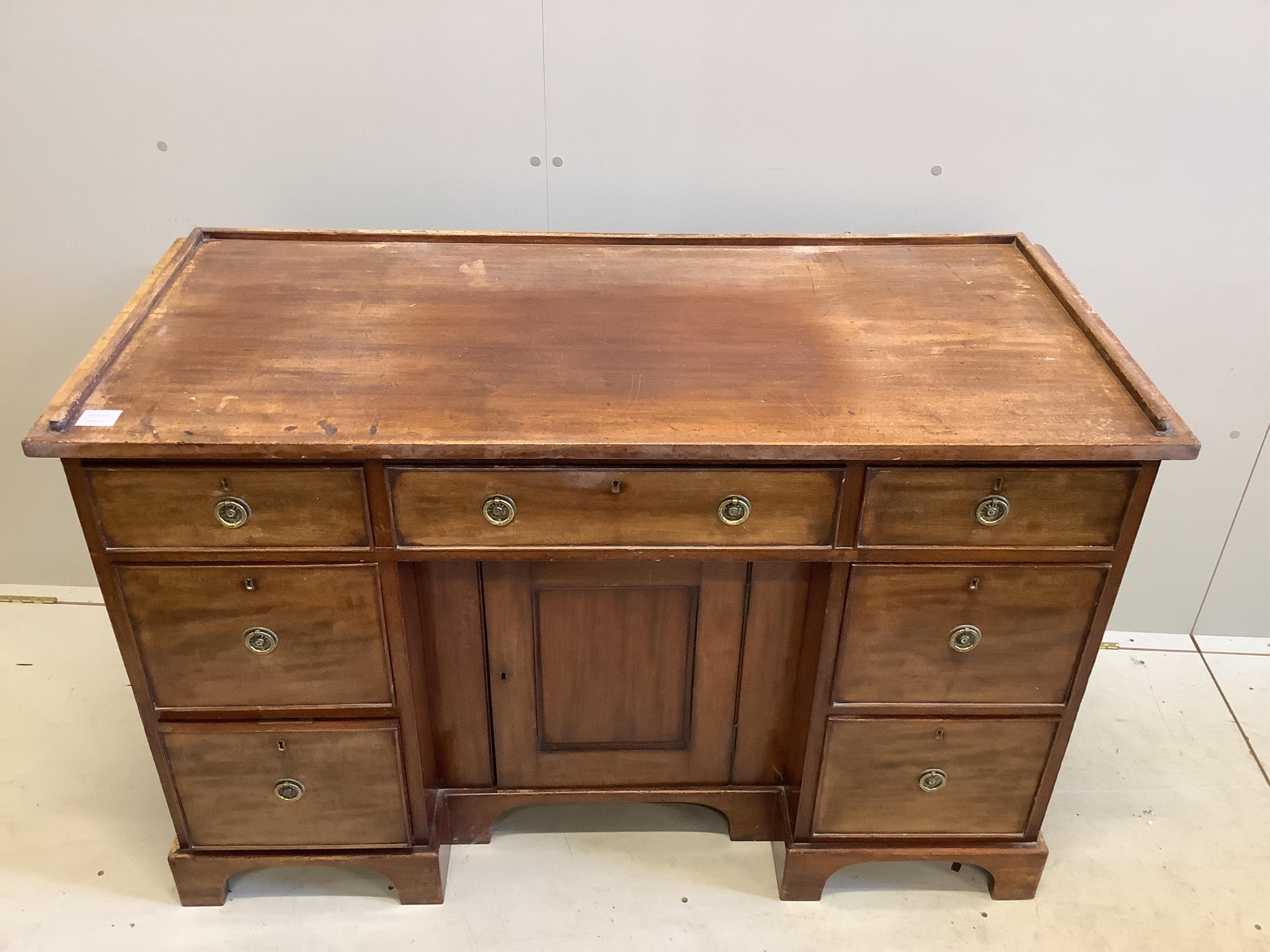 A Regency mahogany galleried topped dressing chest, fitted seven drawers, about a kneehole cupboard, width 127cm, depth 55cm, height 83cm. Condition - fair